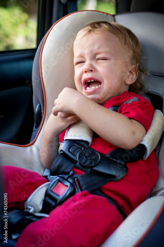 crying baby boy in car seat