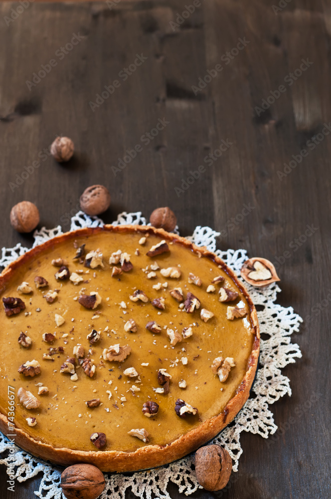 Walnut cake with pumpkin on wooden backgraund Walnut cake with pumpkin on wooden backgraund