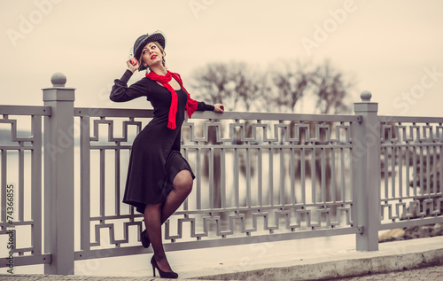 Young pretty sexy lady in black dress outdoor