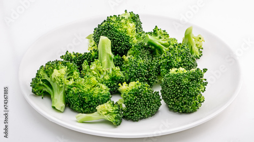 Broccoli on the plate isolated in white.