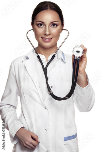 Female doctor examing with stethoscope photo