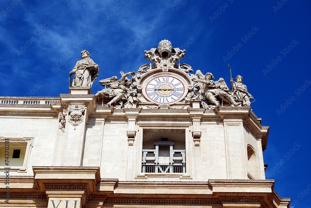 Sculptures and clock on the facade of Vatican city works
