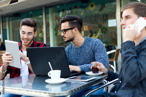 Outdoor portrait of young entrepreneurs working at coffee bar.