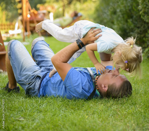 Little girl playing outdoor with her father