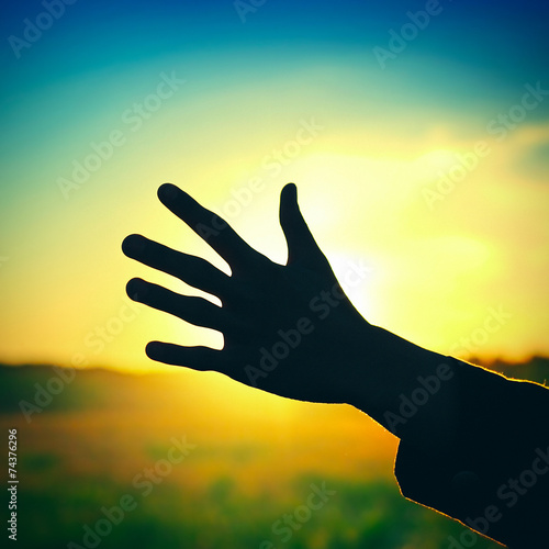 Hand on Sunset Background