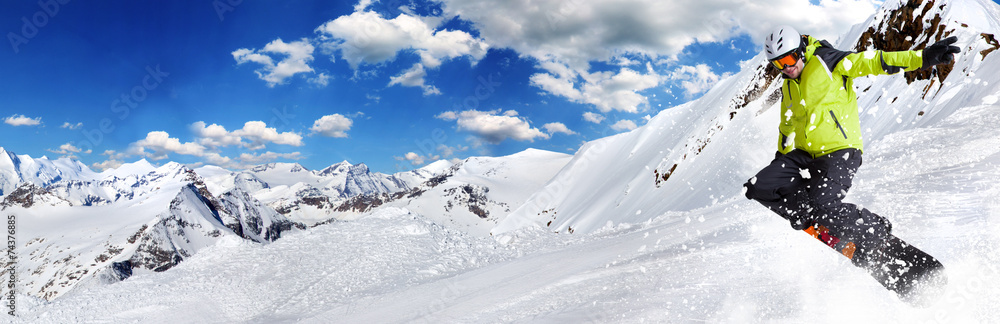 Snowboarder in high mountains