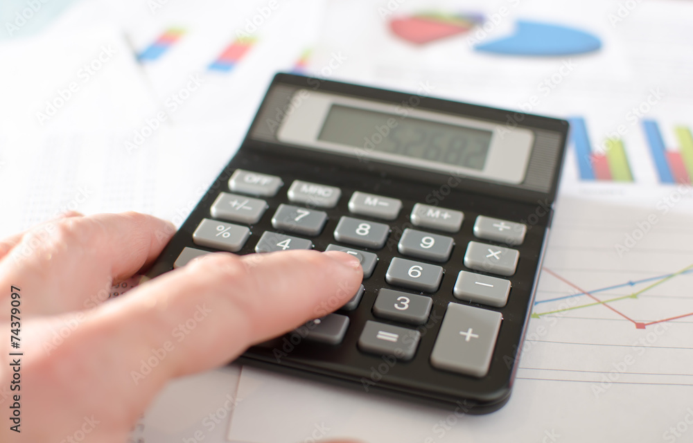 Businesswoman working with calculator Businesswoman working with calculator