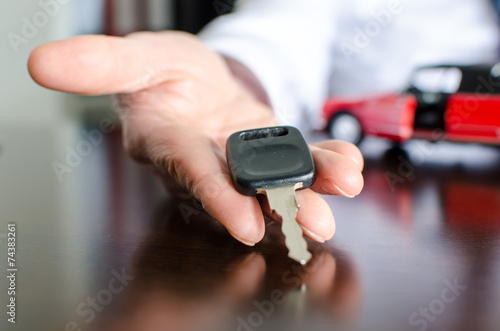 Salesman holding car key