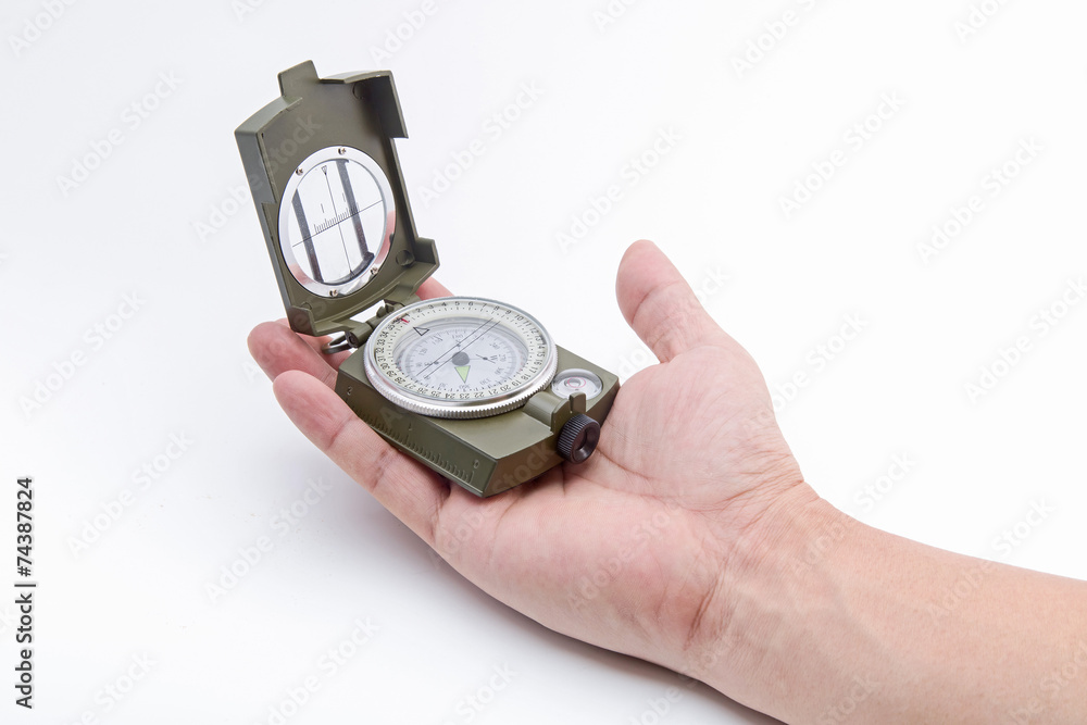 The hand holding the Army green Compass isolation on white. The hand holding the Army green Compass isolation on white.