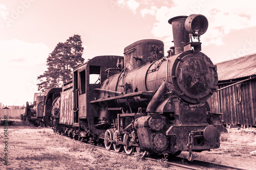 old rusty steam locomotive in retro style in brown tones