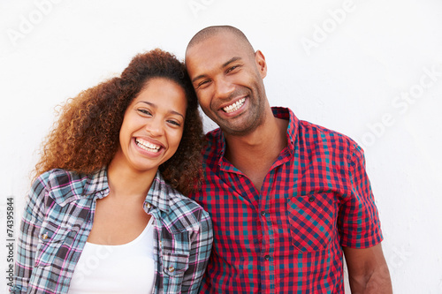 Portrait Of Couple Standing Outdoors Against White Wall