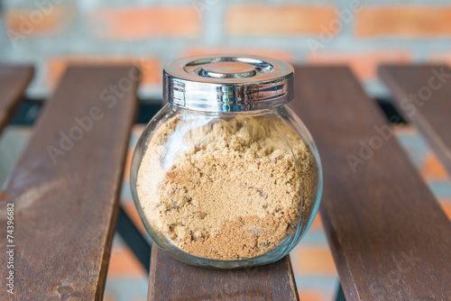 Obraz na plátně Brown sugar in glass bottle
