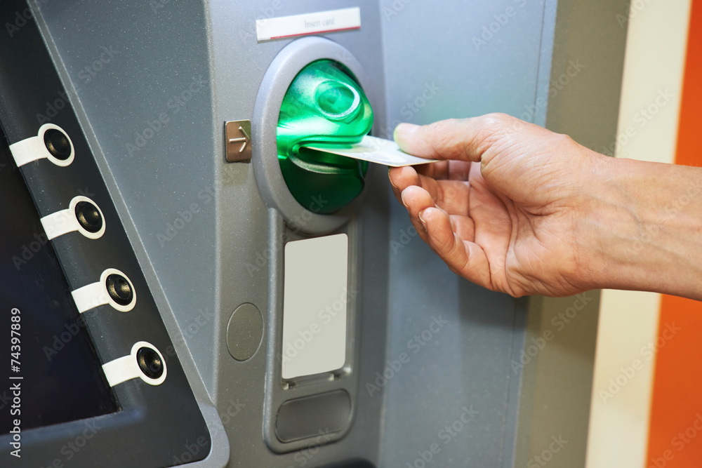 Inserting plastic card into ATM Inserting plastic card into ATM