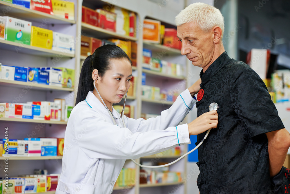 Chinese pharmacy woman with patient