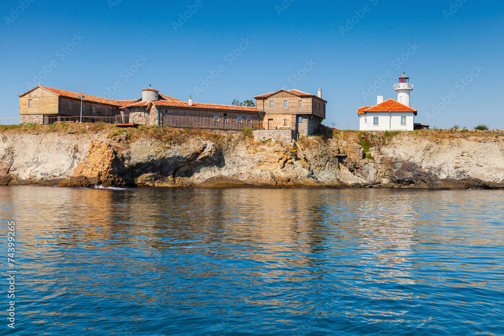 Lighthouse and old wooden buildings on Island