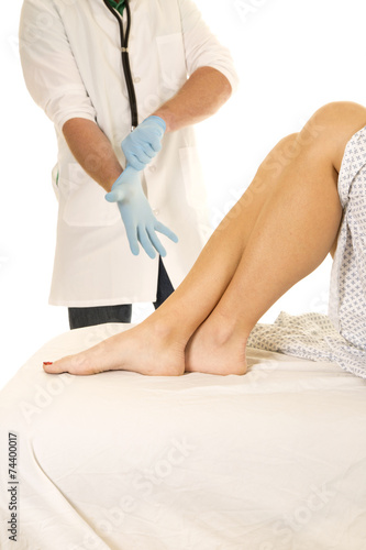 Woman patient legs doctor put on glove