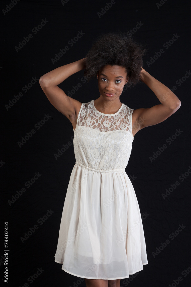 Black woman in white dress smiling at the camera Black woman in white dress smiling at the camera