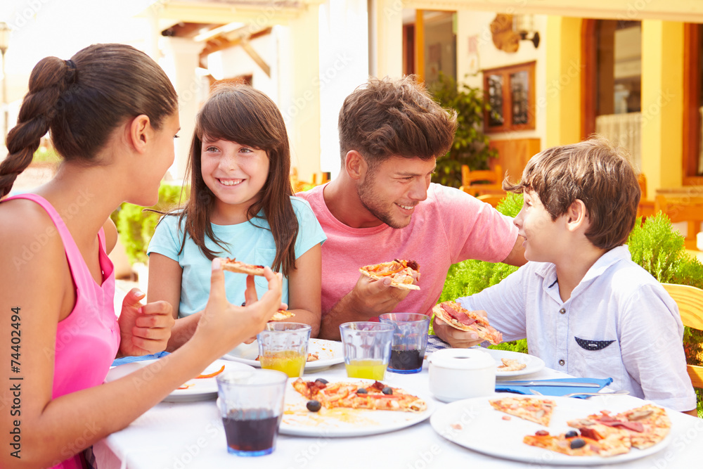 Family Eating Meal At Outdoor Restaurant Together Family Eating Meal At Outdoor Restaurant Together