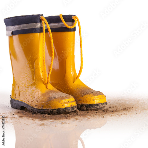 Yellow rubber boots for kids on white background