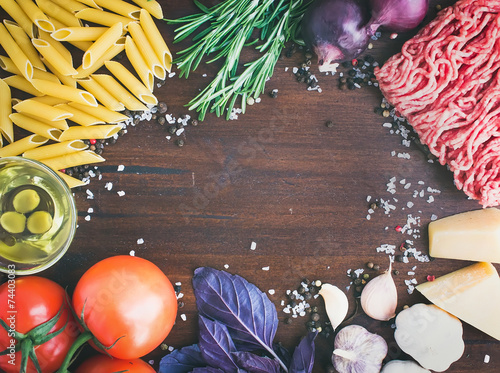 Pasta Bolognese ingredients: penne, minced meat, tomatoes, basil photo