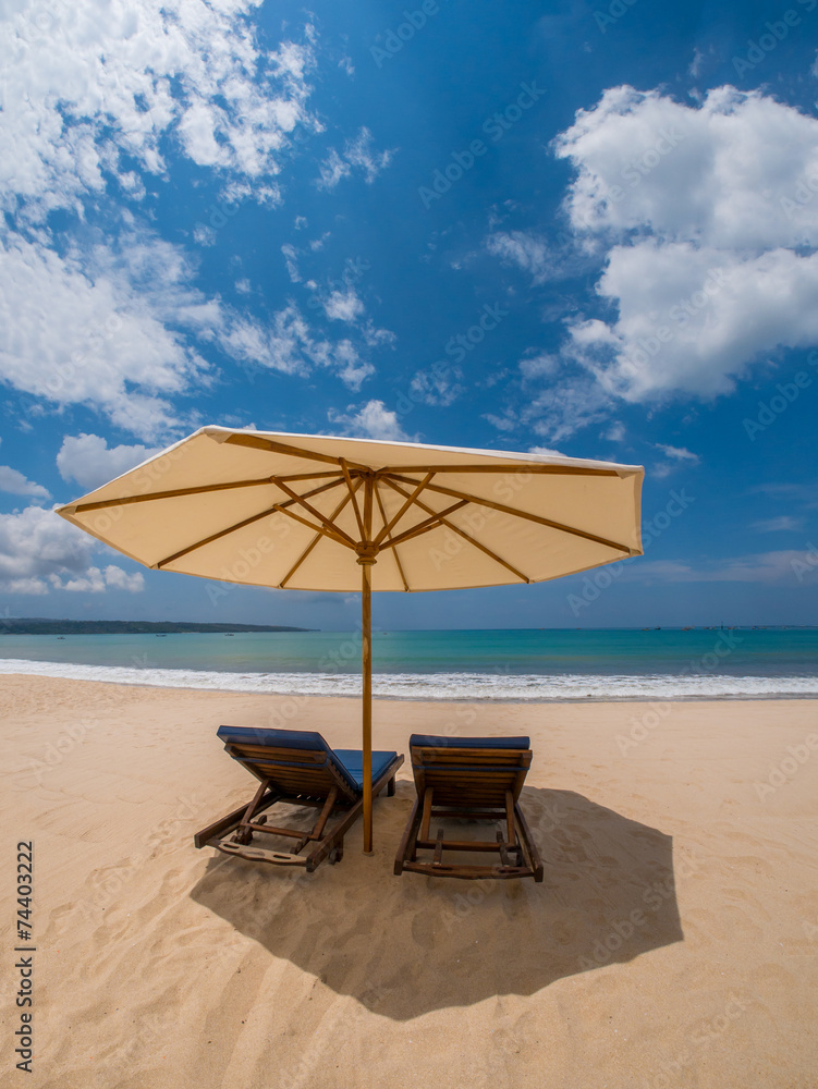 sunbeds with umbrellas on a beautiful sandy beach