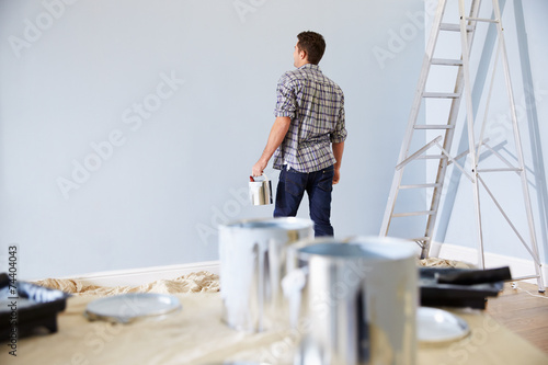 Man Decorating Nursery For New Baby photo