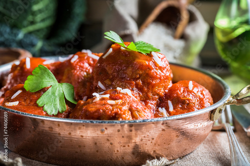 Closeup of meatballs in tom...