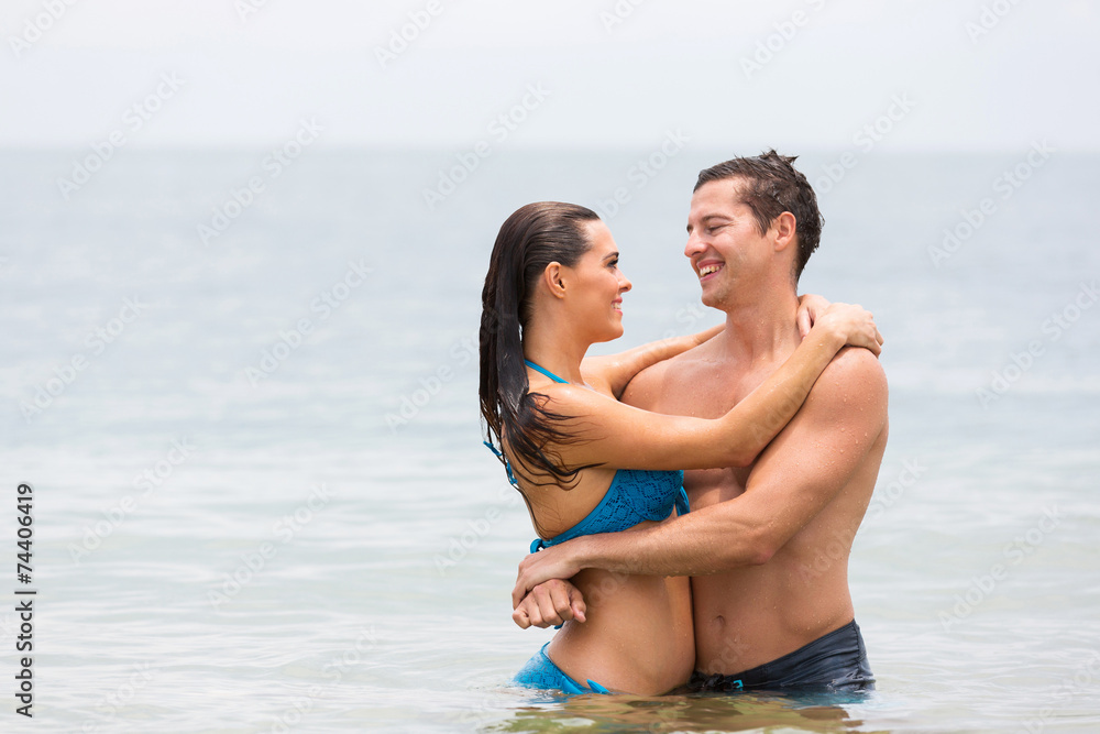 young couple embracing in the ocean