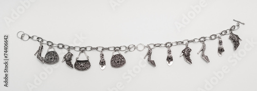isolated charming silver bracelet with miniature pendants