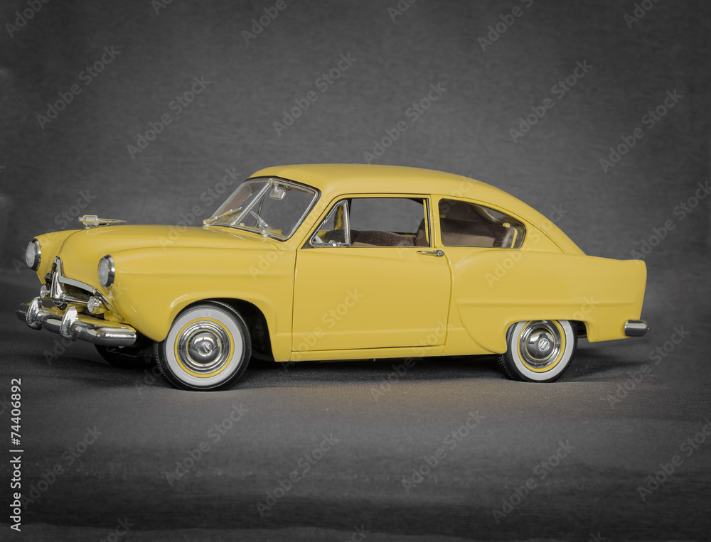 old vintage retro classic car model isolated on grey background
