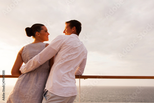 back view of young couple looking at each other on cruise