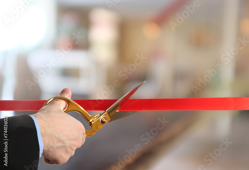 Grand opening, cutting red ribbon