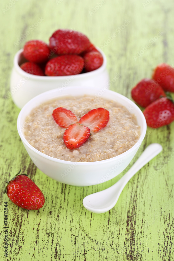 Tasty oatmeal with strawberry on table close-up Tasty oatmeal with strawberry on table close-up