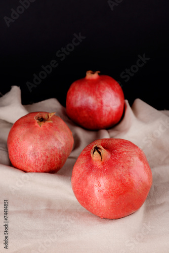 Juicy ripe pomegranates on dark background