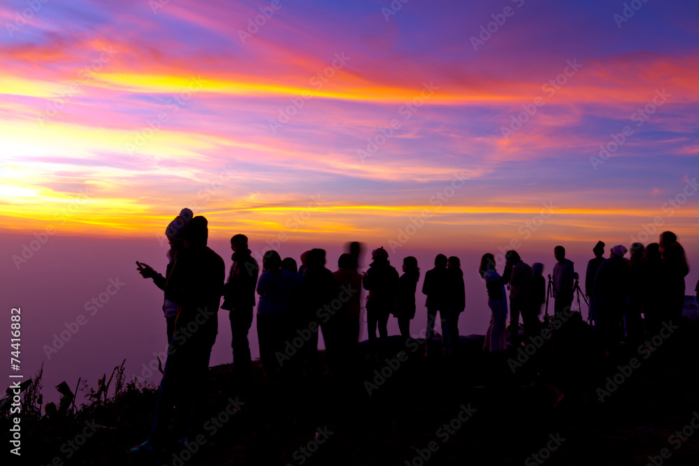 Group of people on top of a mountain waiting for take photo with Group of people on top of a mountain waiting for take photo with