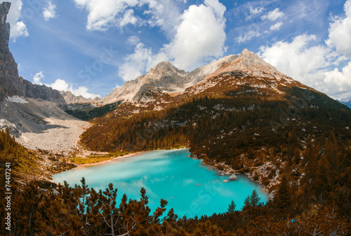 Stunning azure color of mountain lake surrounded by vegetation a
