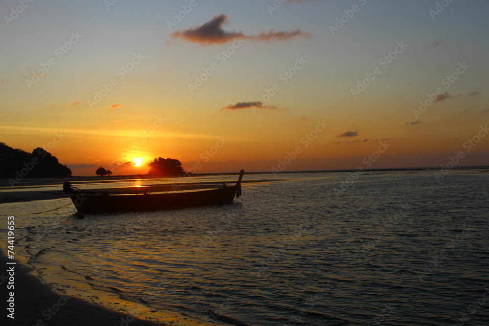 beautiful sunset with floating boat