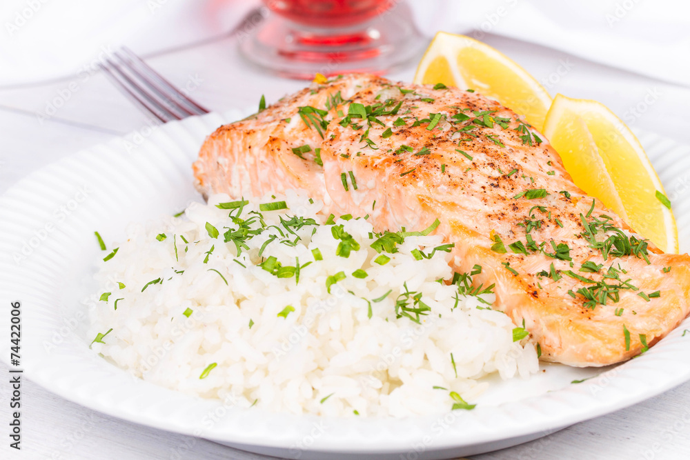Steamed salmon with fresh herbs and lemon. Rice as a garnish Steamed salmon with fresh herbs and lemon. Rice as a garnish
