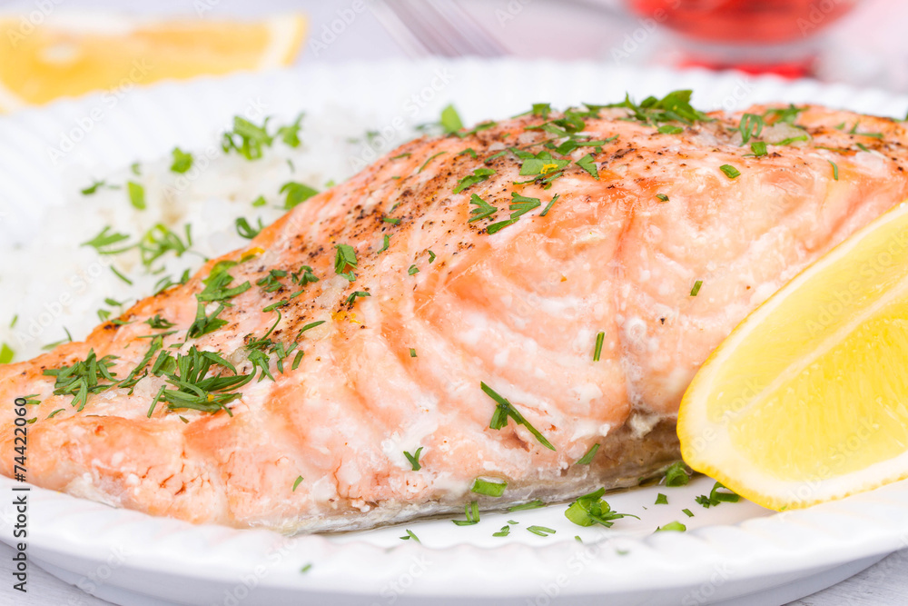 Steamed salmon with fresh herbs and lemon. Rice as a garnish Steamed salmon with fresh herbs and lemon. Rice as a garnish