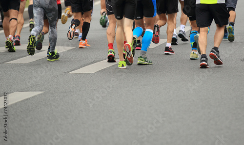 marathon runner legs running on street © lzf