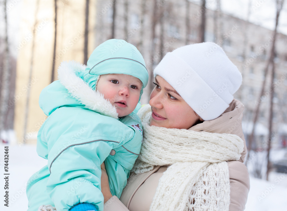 Happy family mother and baby in park in winter Happy family mother and baby in park in winter
