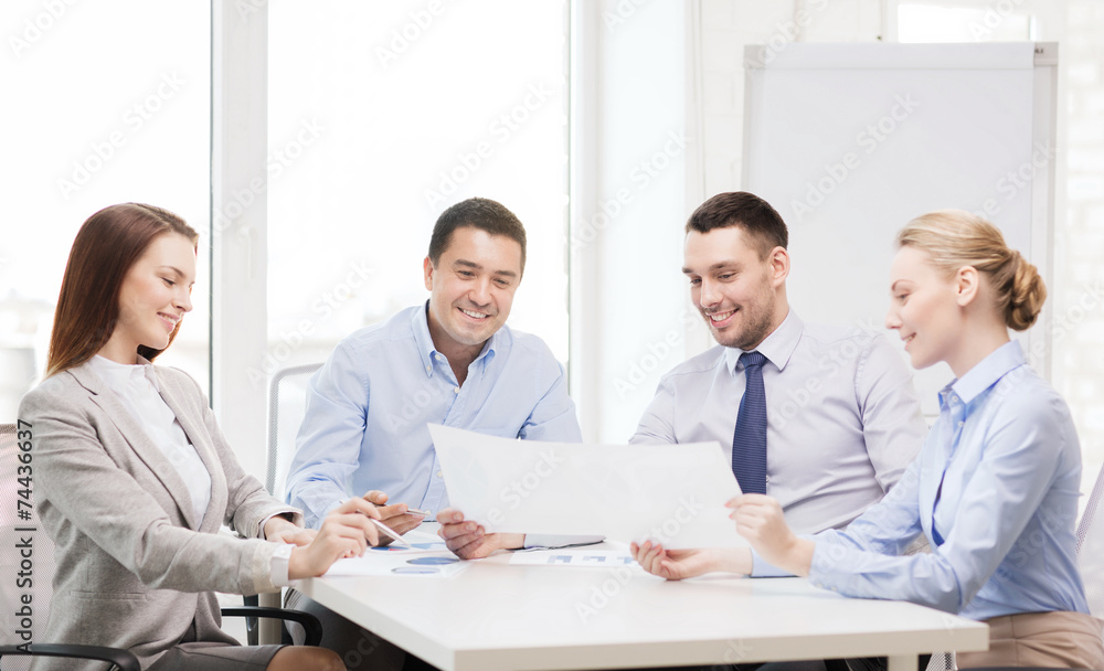 smiling business team having discussion in office smiling business team having discussion in office