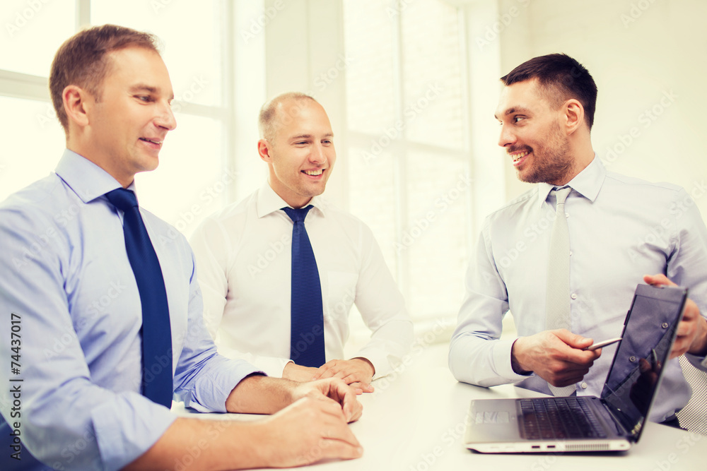 smiling businessmen having discussion in office smiling businessmen having discussion in office