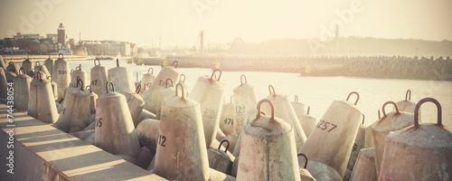 Photos Retro filtered photo of concrete block breakwater in Kolobrzeg, Poland
