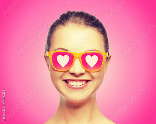 smiling teenage girl in pink sunglasses