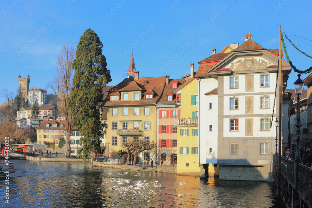 Ancient painted lodges on river bank. Lucerne, Switzerland