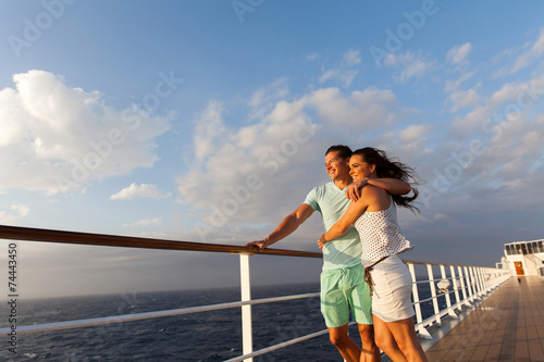 married couple standing on cruise deck