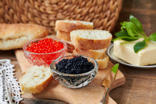 Red and black caviar in glass jars,bread and butter
