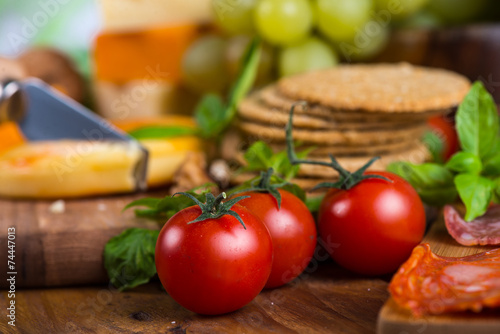 Fresh organic tomatoes with soft cheese and crackers
