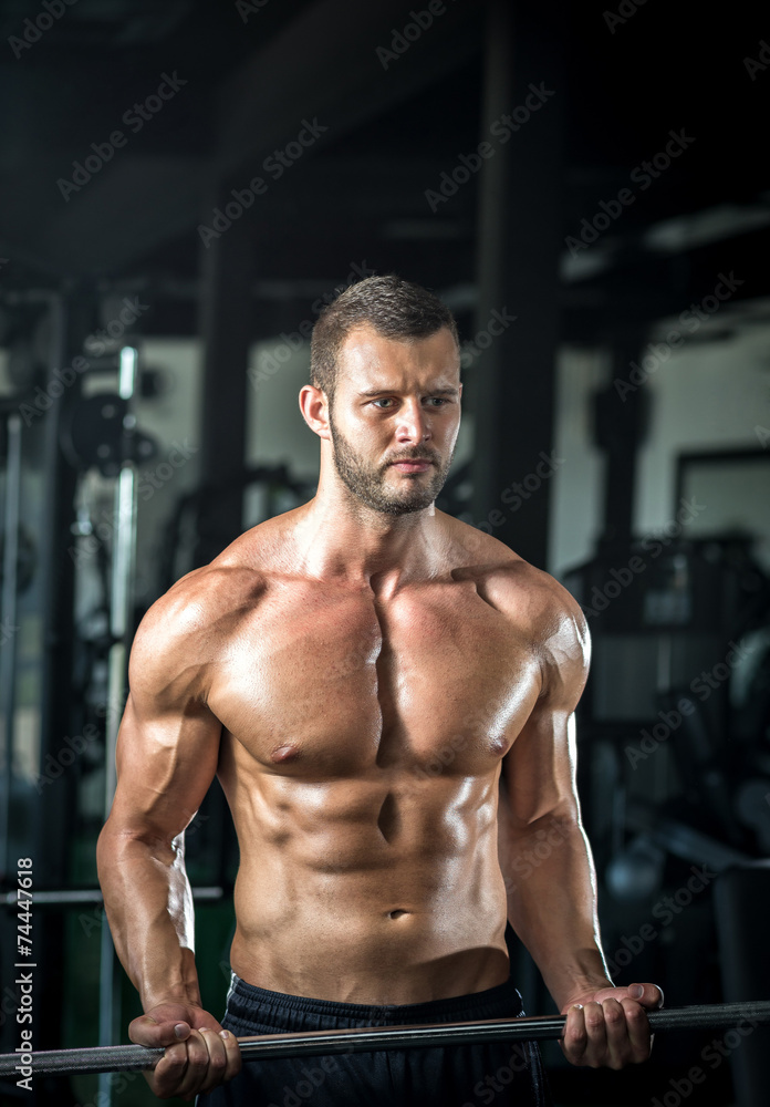 Man doing weight lifting in gym Man doing weight lifting in gym